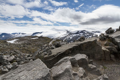 Scenic view of mountains against cloudy sky