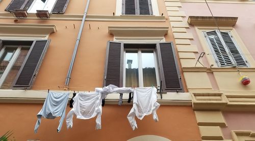 Low angle view of clothes drying against building