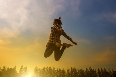 Low angle view of silhouette person against sky