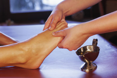 Cropped hand of woman massaging customer