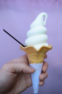 Close-up of hand holding ice cream