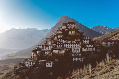 View of building and mountain against blue sky