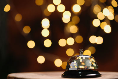 Close-up of illuminated lighting equipment on table