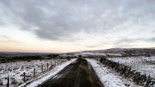 Scenic view of snow covered landscape against sky