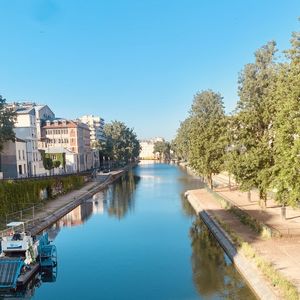 River amidst buildings against clear blue sky