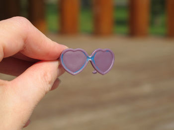 Cropped hand holding toy glass