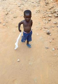 High angle view of cute boy on sand