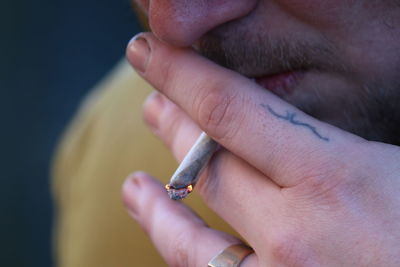 Close-up of man smoking cigarette