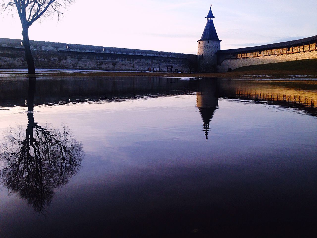 REFLECTION OF BUILDING AND WATER IN A RIVER