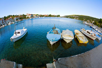 High angle view of boats moored in water against clear sky