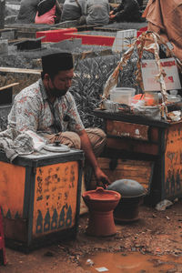 Full length of a man sitting outdoors