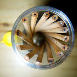 Directly above shot of pencils in glass container