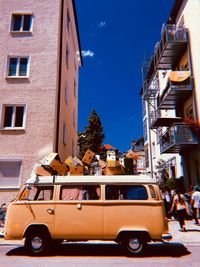 Car on street against buildings in city