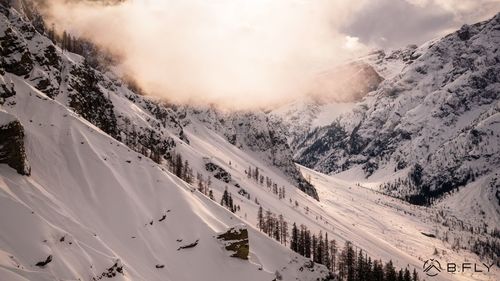 Scenic view of snow covered mountains against sky