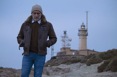 Portrait of adult man in leather jacket with lighthouse. almeria, spain