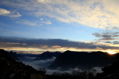 Scenic view of mountains against sky at sunset