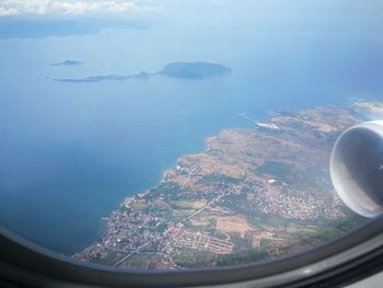 Aerial view of sea seen through airplane window