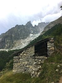 House on mountain against sky