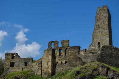 Low angle view of old building against blue sky