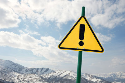 Yellow warning sign in mountains