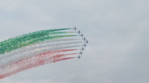 Low angle view of airplane flying against sky