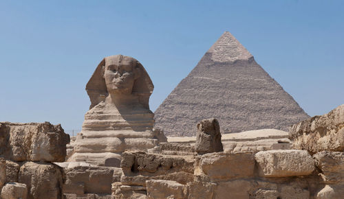 Sphinx and pyramid of khafre against blue sky