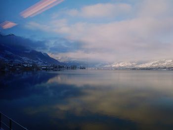 Scenic view of sea by mountains against sky