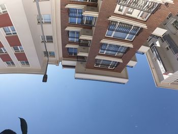 Low angle view of modern buildings against clear blue sky