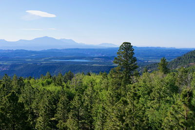 Scenic view of mountains against blue sky