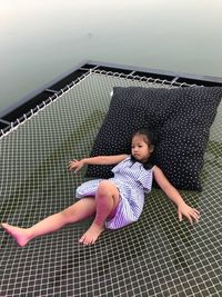 Full length of girl lying on net