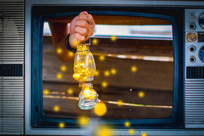 Close-up of hand holding light bulb