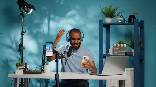 Young man using smart phone at desk