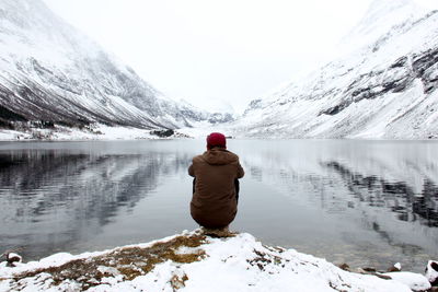 Woman standing on snow covered lake