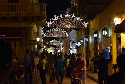 People walking in illuminated building at night