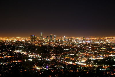 High angle view of city lit up at night