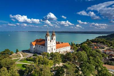 High angle view of townscape by sea against sky