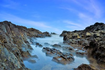 Scenic view of sea and rocks against sky