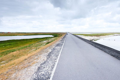 Empty road along countryside landscape