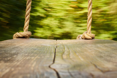 Close-up of rope tied on wooden post