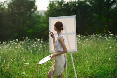 Side view of woman standing on field