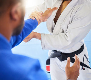 Midsection of doctor examining patient at clinic