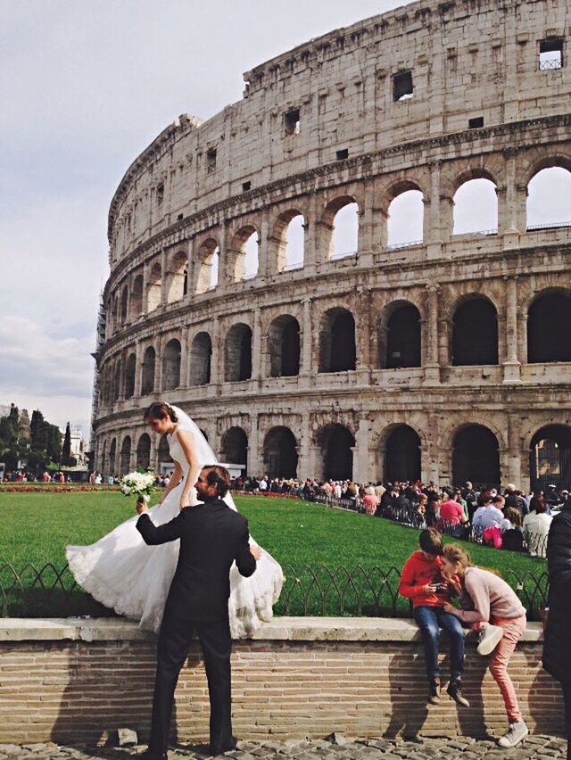 WOMAN WITH UMBRELLA IN FRONT OF HISTORIC BUILDING