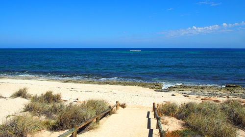 Scenic view of sea against clear blue sky