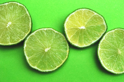 Directly above shot of lemon slice over green background