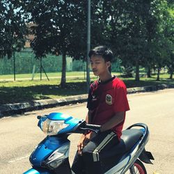 Side view of boy riding motorcycle