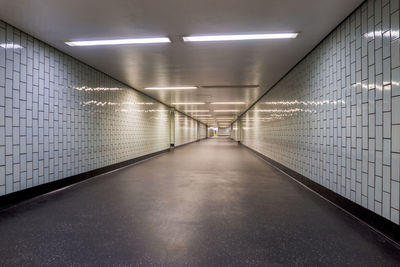 Diminishing perspective of illuminated underground walkway