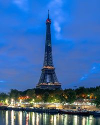 View of illuminated tower against cloudy sky