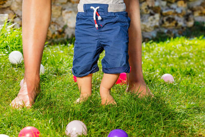 Low section of woman standing on grass