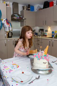 Cute girl having food in kitchen