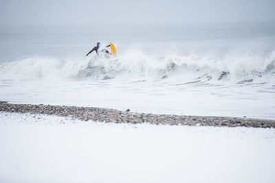 Man surfing during winter snow